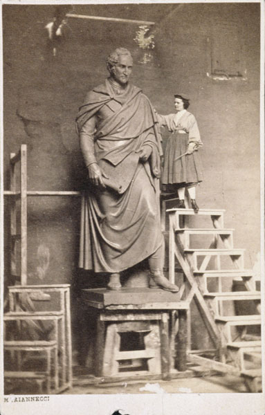 Harriet Hosmer on ladder with her sculpture of Thomas Hart Benton from American Photographer